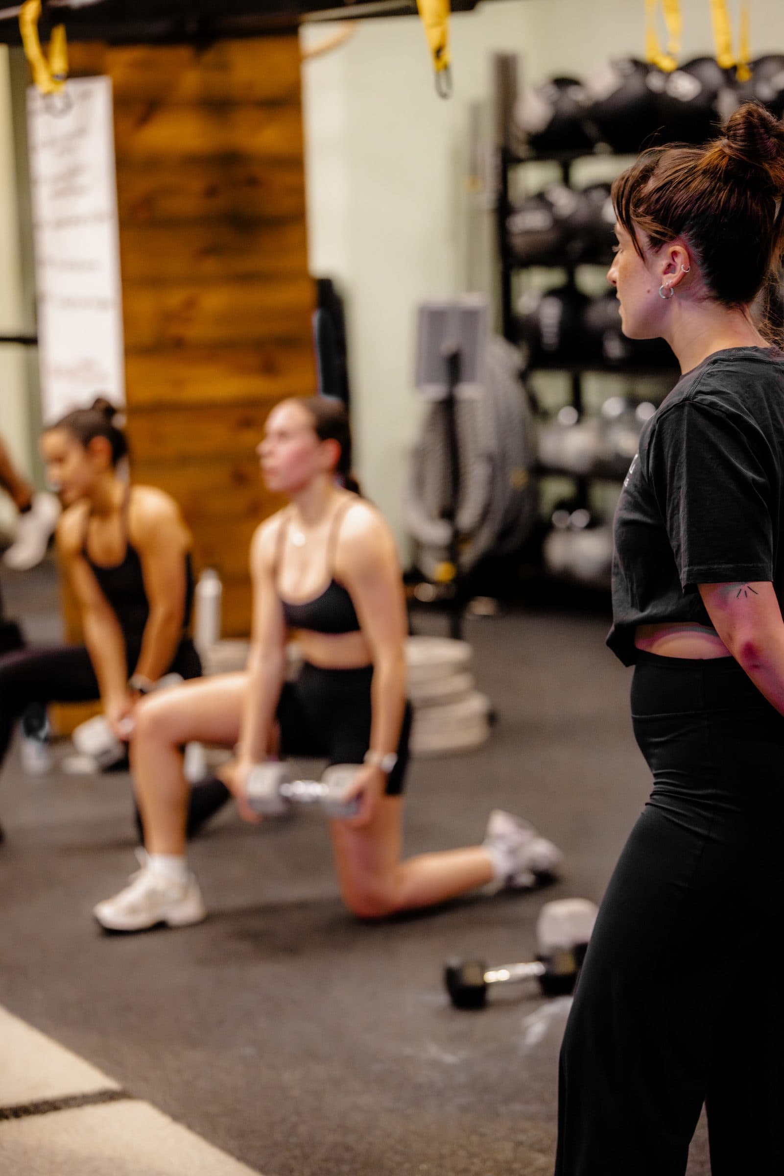 solace-gym-clients-working-out-with-coach-overlooking